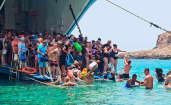 Tourists piling out of a boat at Balos beach, where a floating platform will soon be installed.