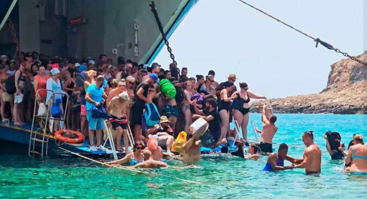 Tourists piling out of a boat at Balos beach, where a floating platform will soon be installed.