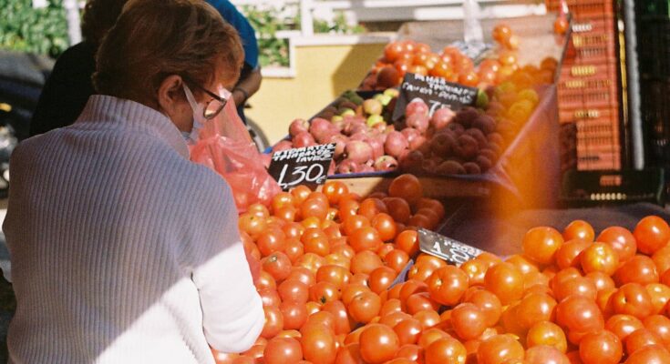 Woman buying tomatoes at a market