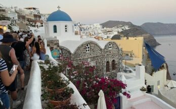 Tourists queueing for a view of Santorini sunset.