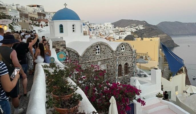 Tourists queueing for a view of Santorini sunset.