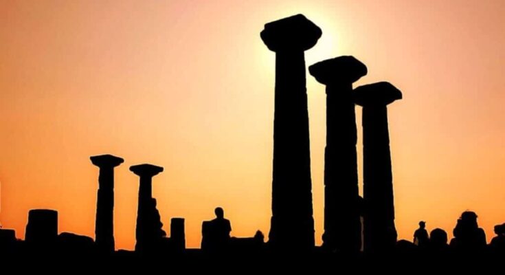 Ruins of the ancient Greek city of Assos, showcasing the remnants of its historical structures against a scenic backdrop.