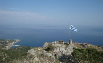 Imerovigli , highest point of othonoi island, has a greek flag on top