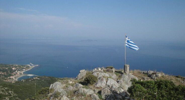 Imerovigli , highest point of othonoi island, has a greek flag on top