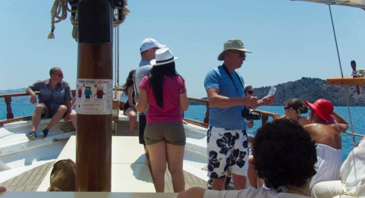 A group of tourists heading for the Volcano of Santorini.