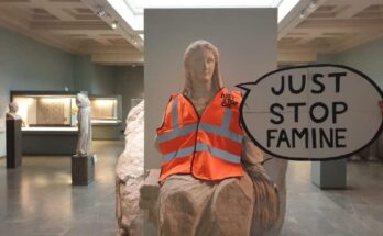 Just Stop Oil high-vis jacket on Greek statue of Demeter