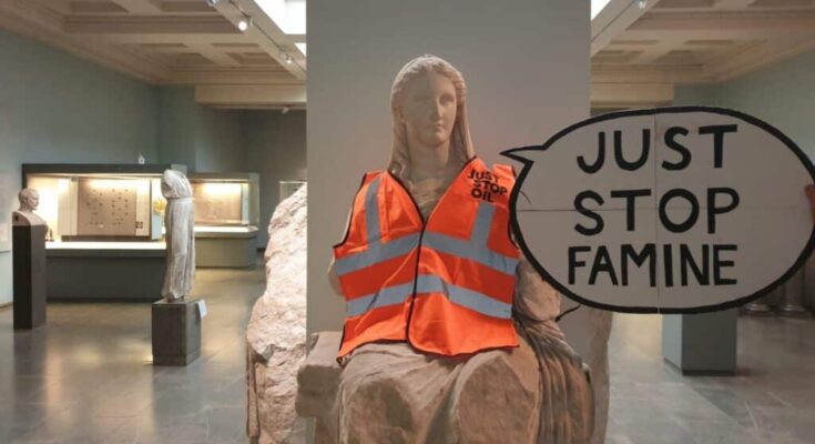 Just Stop Oil high-vis jacket on Greek statue of Demeter