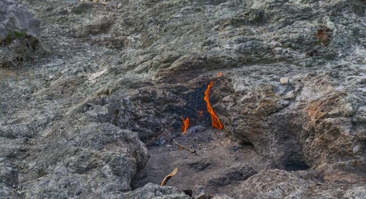 Flames rise from the cracks of Yanartaş, the burning mountain, in Olympos Beydagları National Park, Turkey